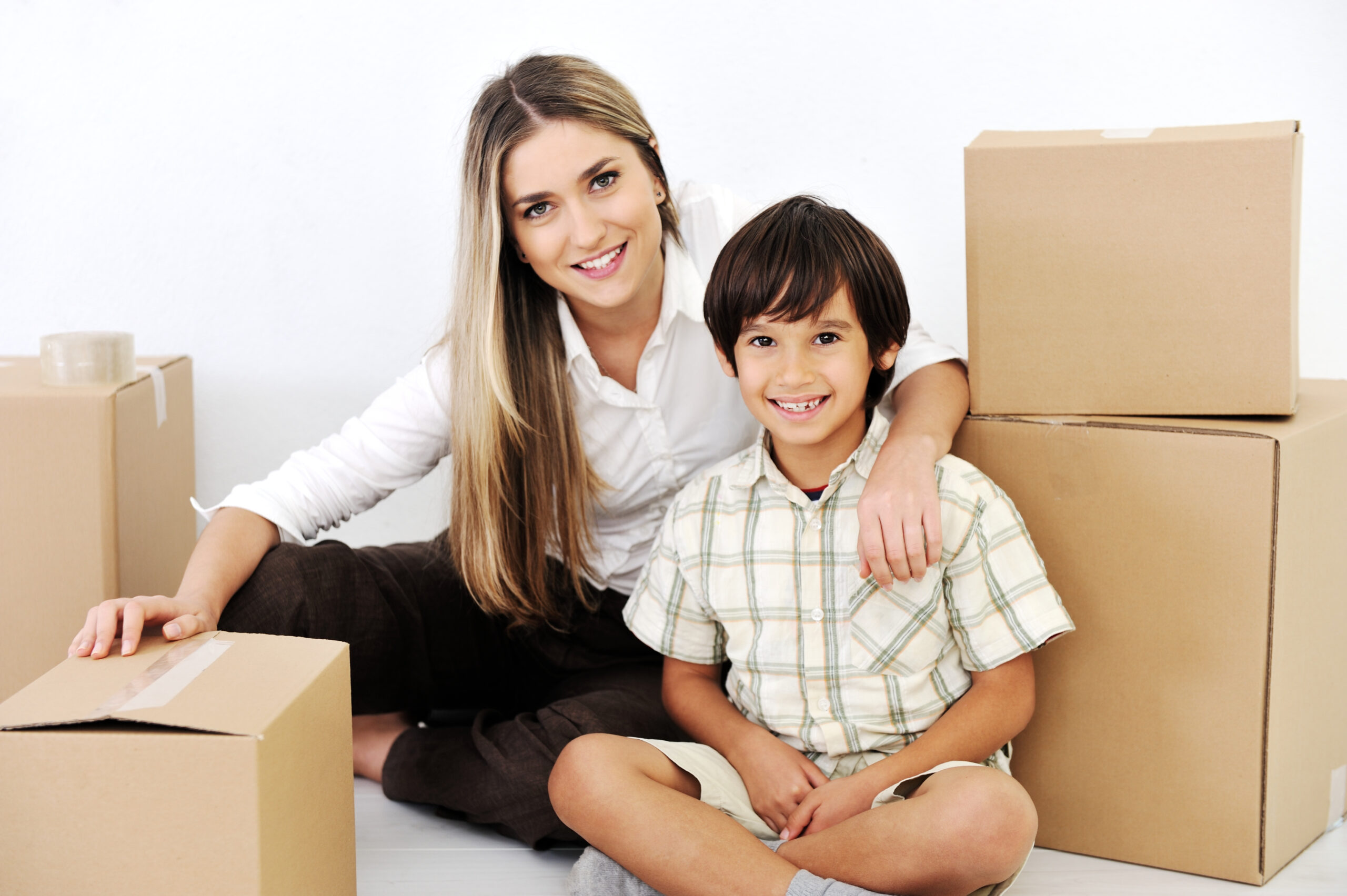 beautiful smiling woman and little boy openig cardboard box_SKWg0h_Trs scaled