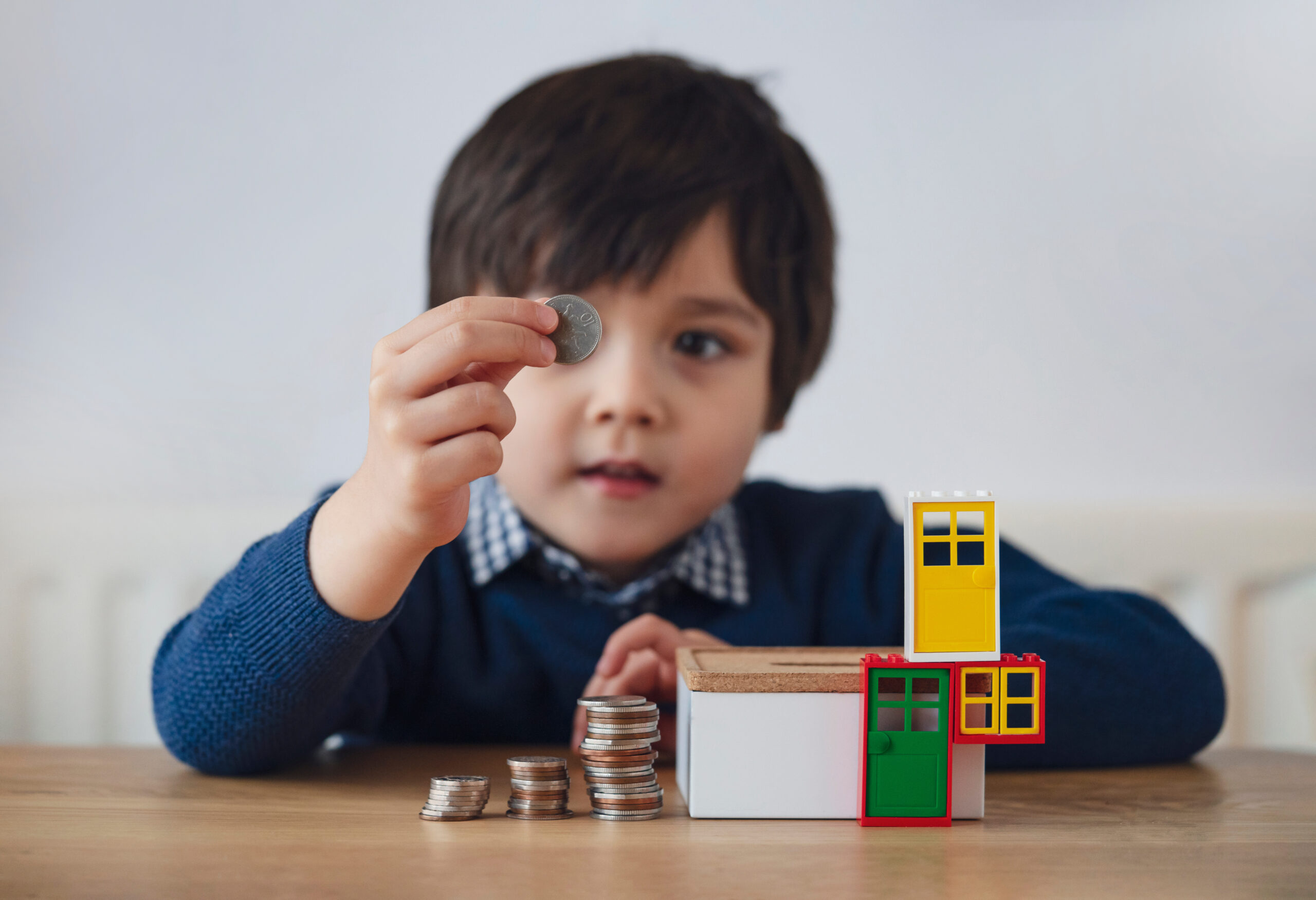 child playing with coins and toys