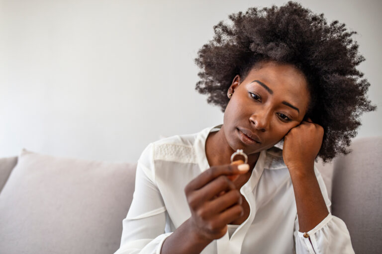 woman holding wedding ring divorce