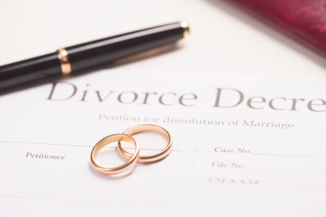 Divorce decree, wedding rings, pen