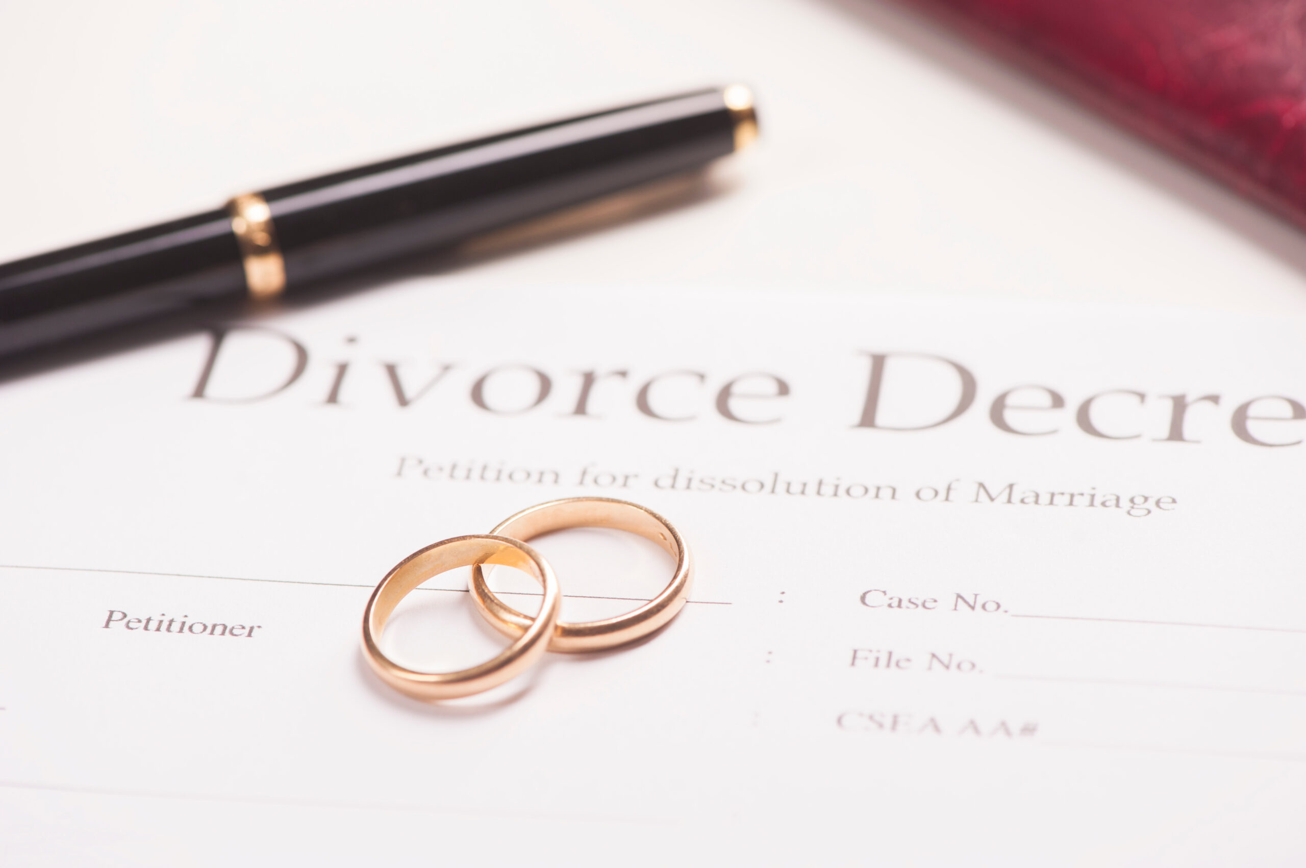 Divorce decree, wedding rings, pen