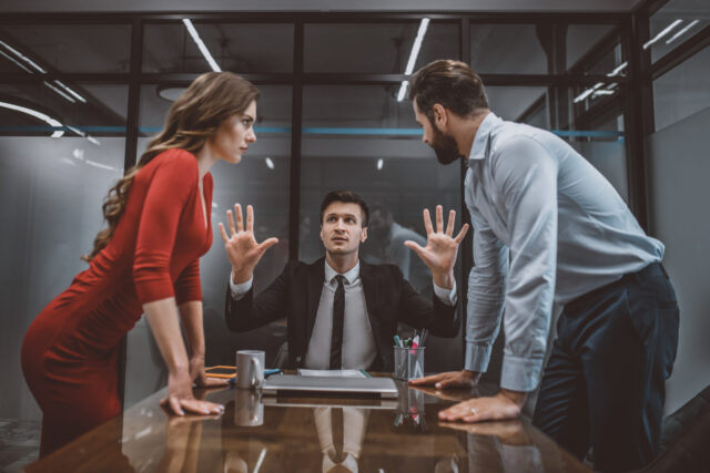 Hot argument. A mediator trying to stop the argument between spouses mediation