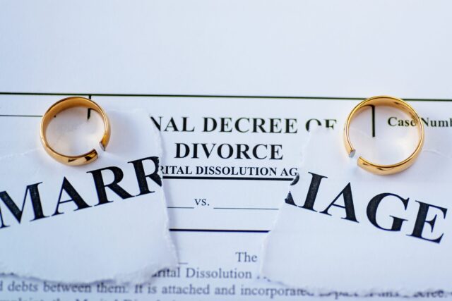 Divorce decree and two broken wedding rings