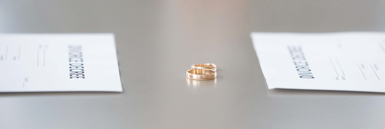 Close up view of decree paper and rings on table