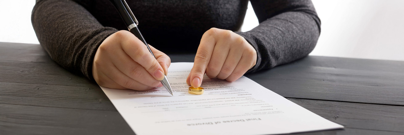 Hands of wife husband signing decree of divorce dissolution canceling marriage legal separation documents filing divorce papers or premarital agreement prepared by lawyer