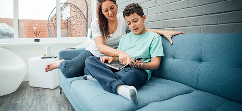 Little boy and his mother are reading a book