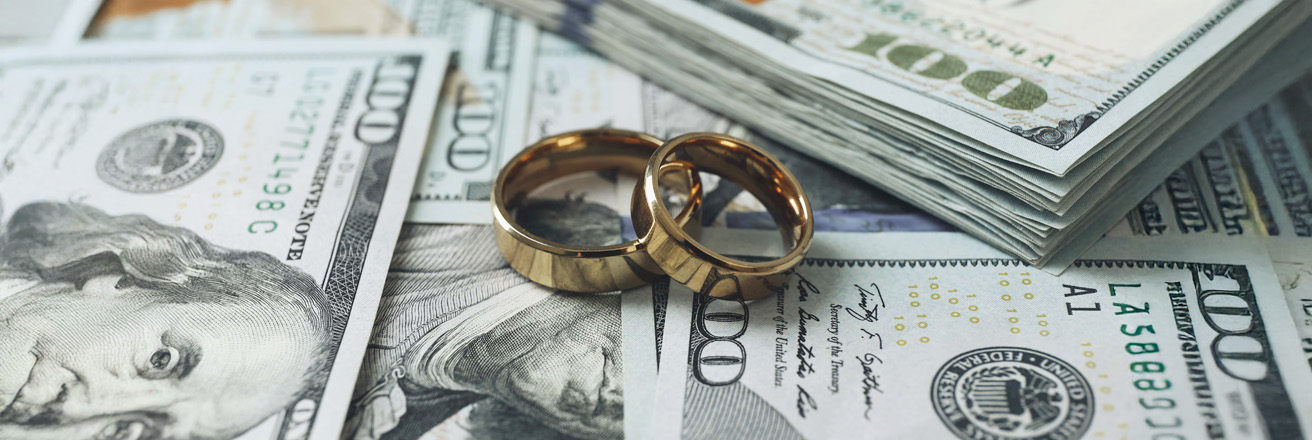 wedding rings sitting on money