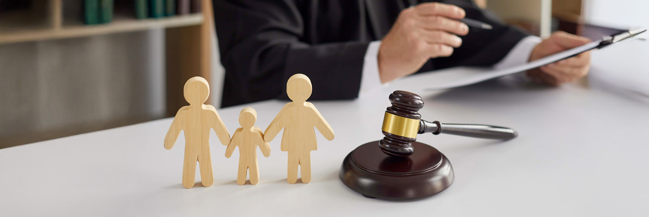 wooden family blocks on desk with gavel and judge