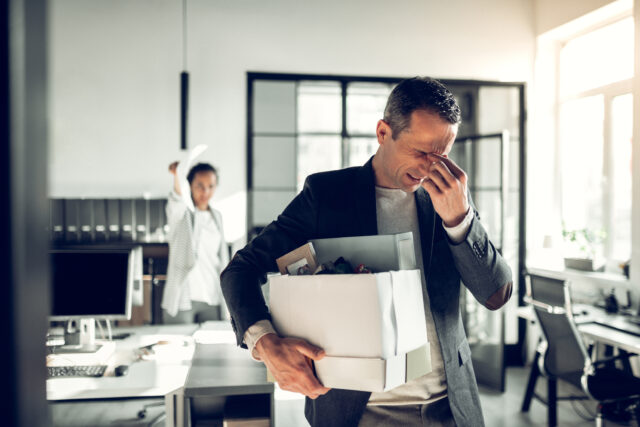 Man having headache. Man having headache while listening to his crazy female boss and leaving the office